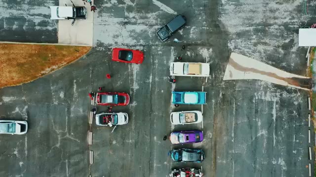 Drone aerial view of the car show lot packed with vehicles