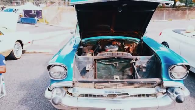 Turquoise 1957 Chevrolet with the hood up